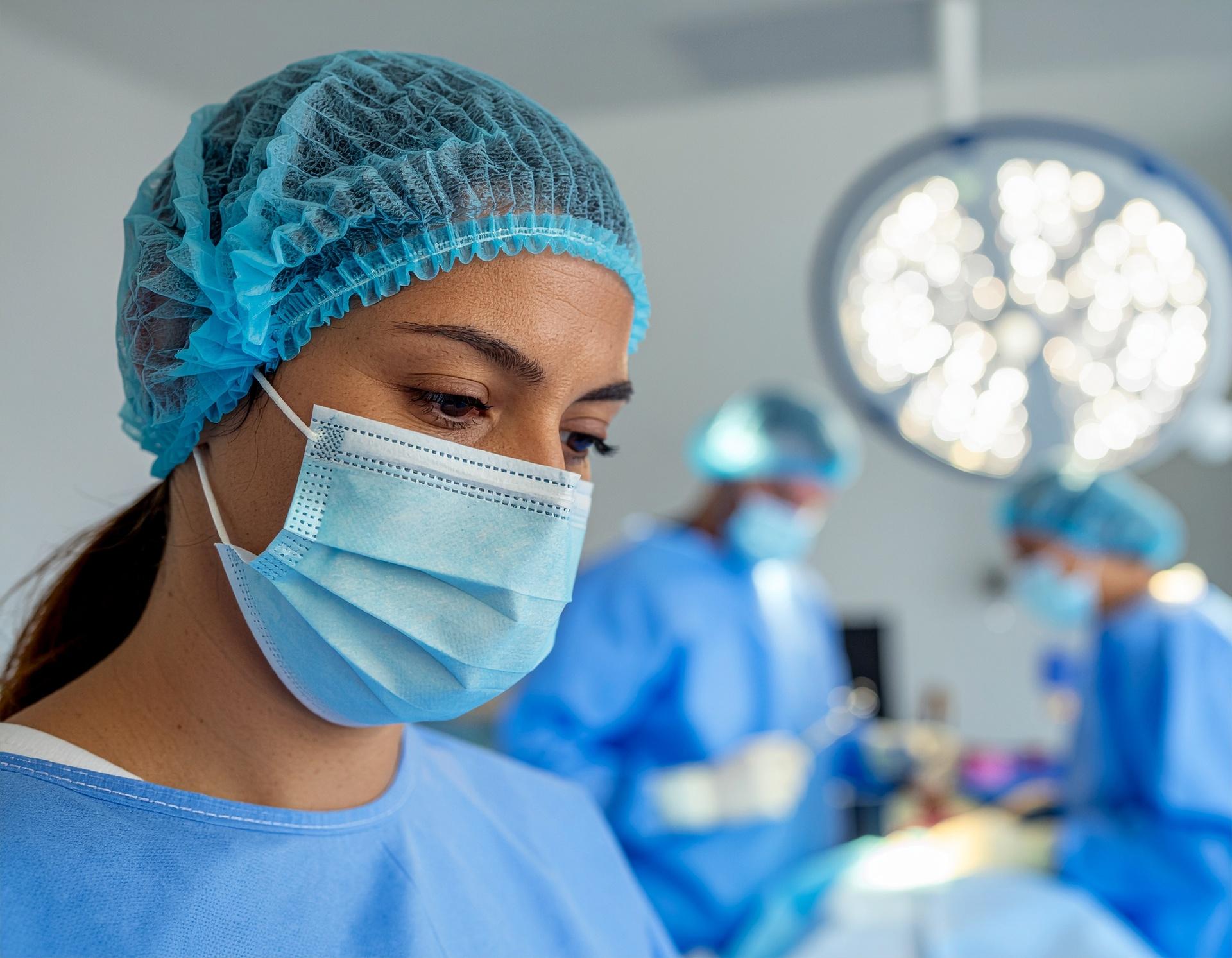Focused surgical team working under bright operating lights